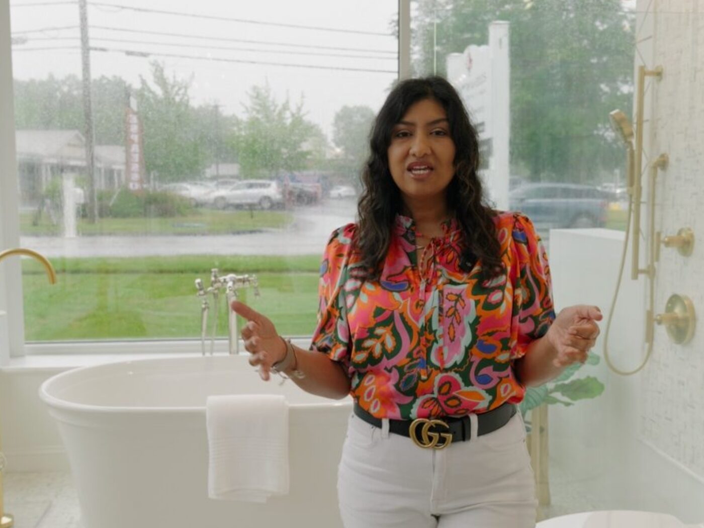 Claudia of Artisan Tile speaking on camera in the studio's showroom
