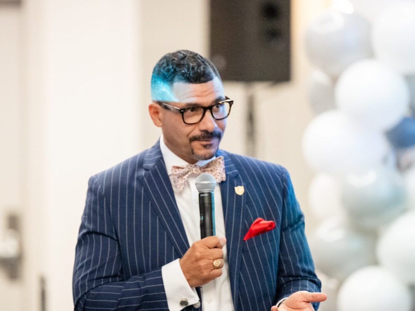 Dr. Steve Perry speaking on stage during a keynote